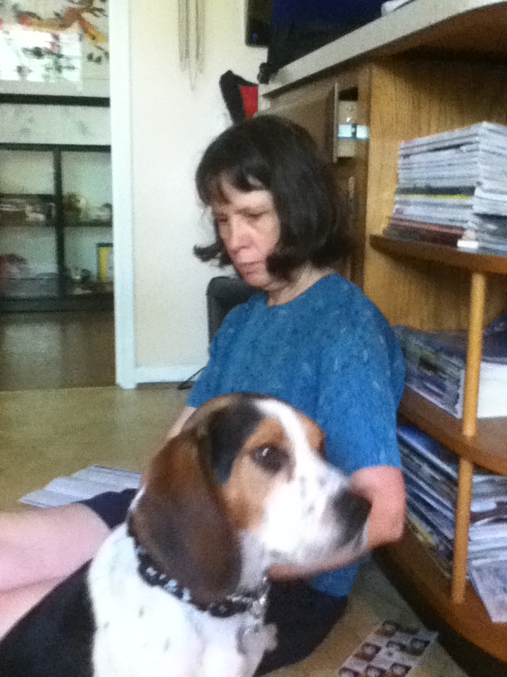 Galileo with Dianne, reading in front of a bookcase